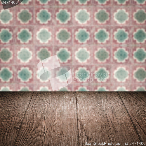 Image of Wood table top and blur vintage ceramic tile pattern wall