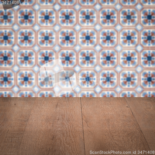 Image of Wood table top and blur vintage ceramic tile pattern wall
