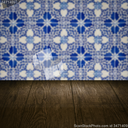 Image of Wood table top and blur vintage ceramic tile pattern wall