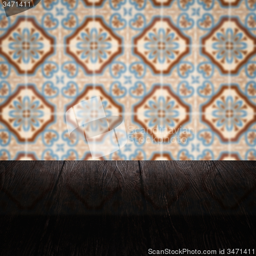Image of Wood table top and blur vintage ceramic tile pattern wall