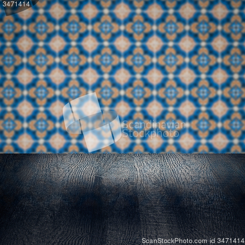 Image of Wood table top and blur vintage ceramic tile pattern wall