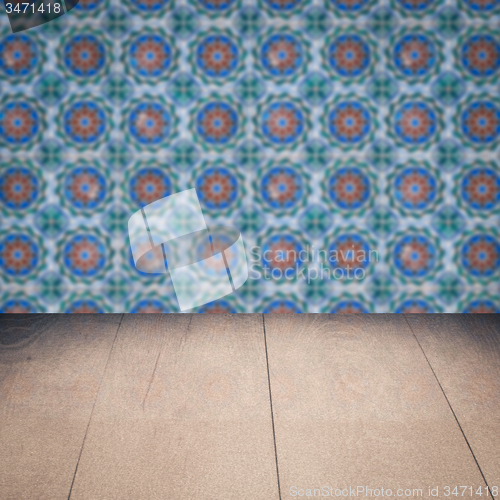 Image of Wood table top and blur vintage ceramic tile pattern wall