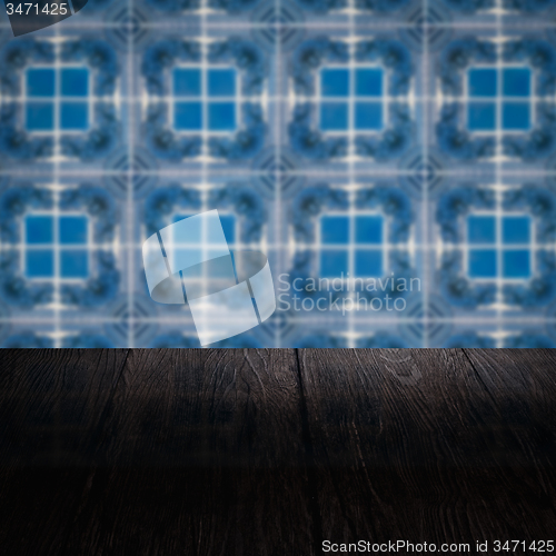 Image of Wood table top and blur vintage ceramic tile pattern wall