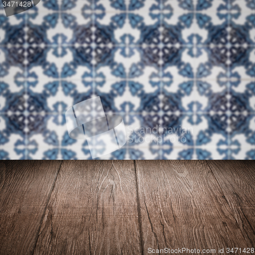 Image of Wood table top and blur vintage ceramic tile pattern wall