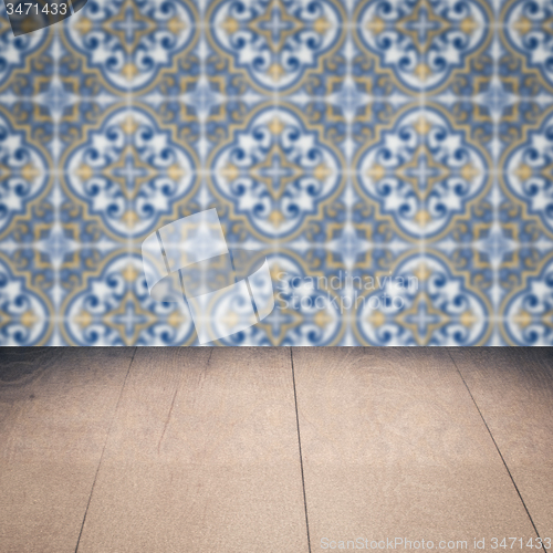 Image of Wood table top and blur vintage ceramic tile pattern wall