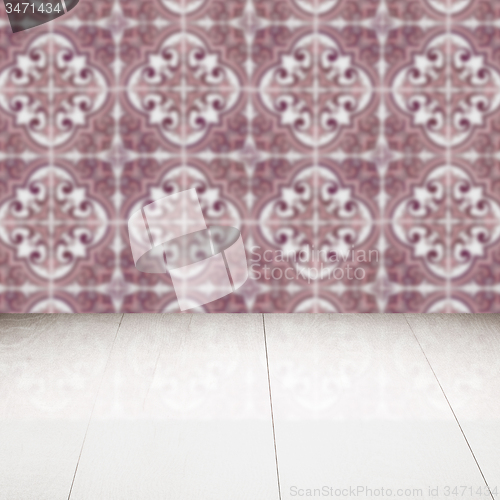 Image of Wood table top and blur vintage ceramic tile pattern wall