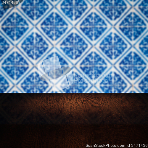 Image of Wood table top and blur vintage ceramic tile pattern wall