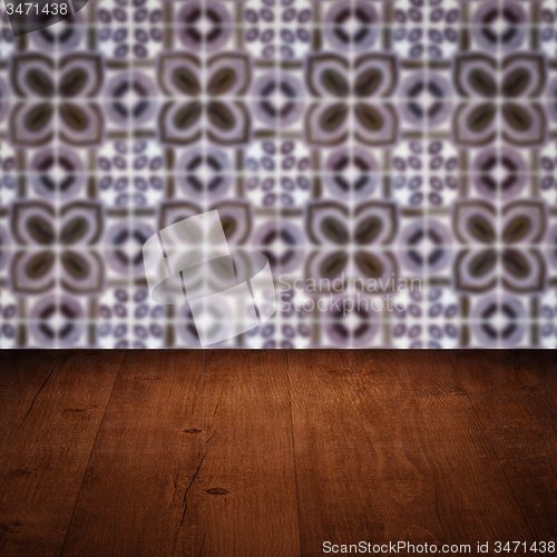 Image of Wood table top and blur vintage ceramic tile pattern wall