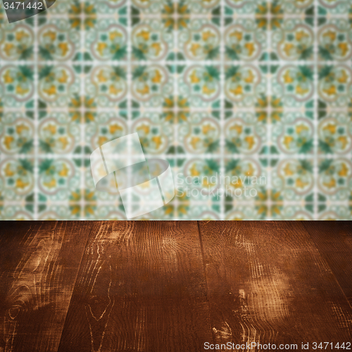 Image of Wood table top and blur vintage ceramic tile pattern wall