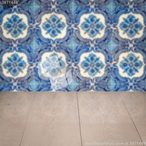 Image of Wood table top and blur vintage ceramic tile pattern wall