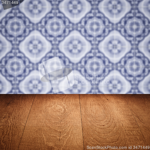 Image of Wood table top and blur vintage ceramic tile pattern wall