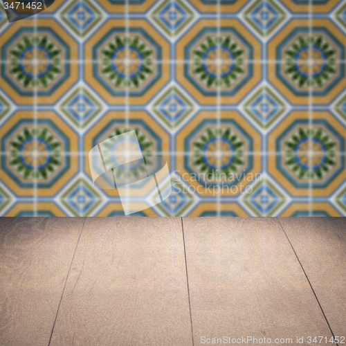 Image of Wood table top and blur vintage ceramic tile pattern wall