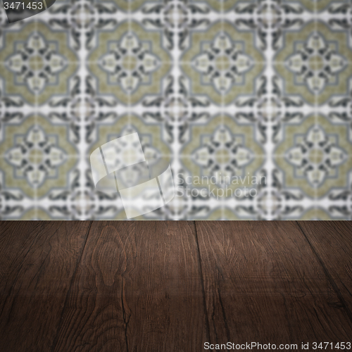 Image of Wood table top and blur vintage ceramic tile pattern wall