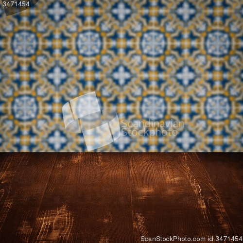 Image of Wood table top and blur vintage ceramic tile pattern wall