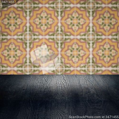 Image of Wood table top and blur vintage ceramic tile pattern wall