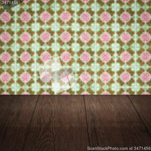 Image of Wood table top and blur vintage ceramic tile pattern wall
