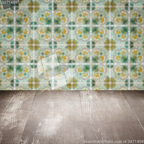 Image of Wood table top and blur vintage ceramic tile pattern wall