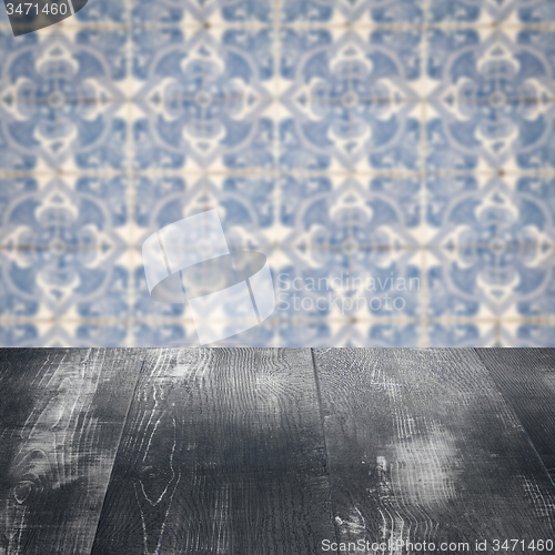 Image of Wood table top and blur vintage ceramic tile pattern wall