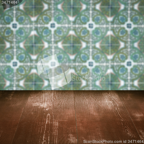 Image of Wood table top and blur vintage ceramic tile pattern wall