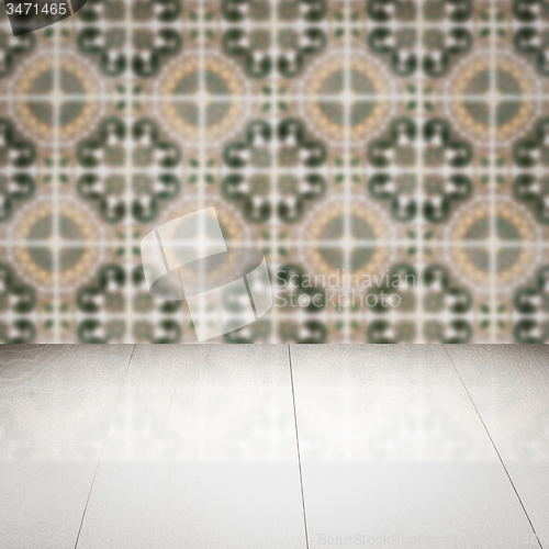 Image of Wood table top and blur vintage ceramic tile pattern wall