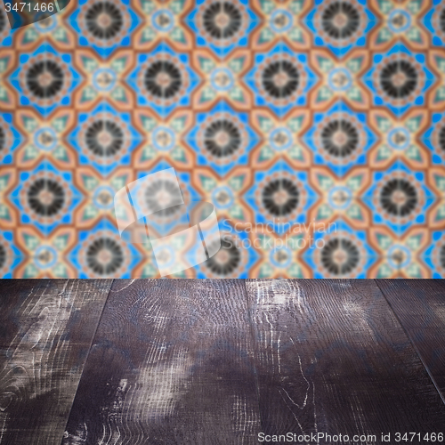 Image of Wood table top and blur vintage ceramic tile pattern wall