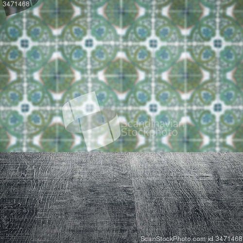 Image of Wood table top and blur vintage ceramic tile pattern wall