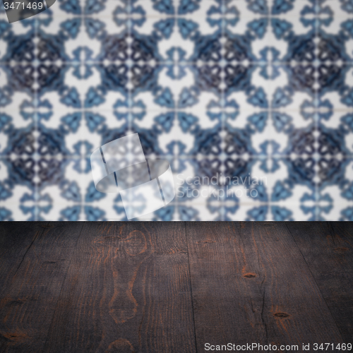 Image of Wood table top and blur vintage ceramic tile pattern wall