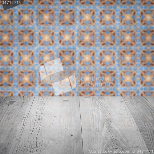 Image of Wood table top and blur vintage ceramic tile pattern wall
