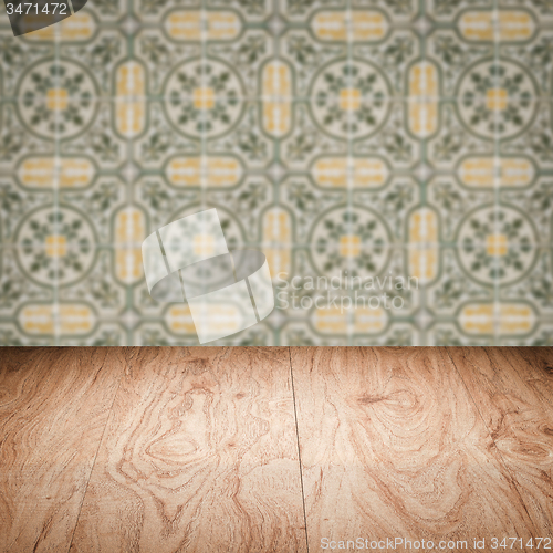 Image of Wood table top and blur vintage ceramic tile pattern wall