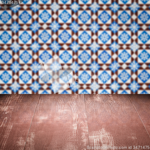 Image of Wood table top and blur vintage ceramic tile pattern wall
