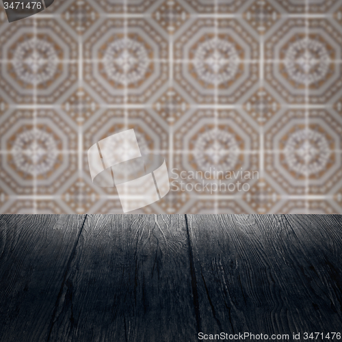 Image of Wood table top and blur vintage ceramic tile pattern wall