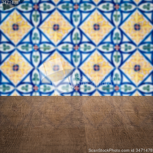 Image of Wood table top and blur vintage ceramic tile pattern wall