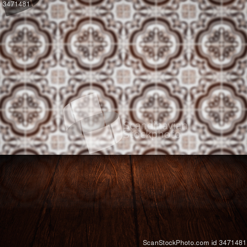 Image of Wood table top and blur vintage ceramic tile pattern wall