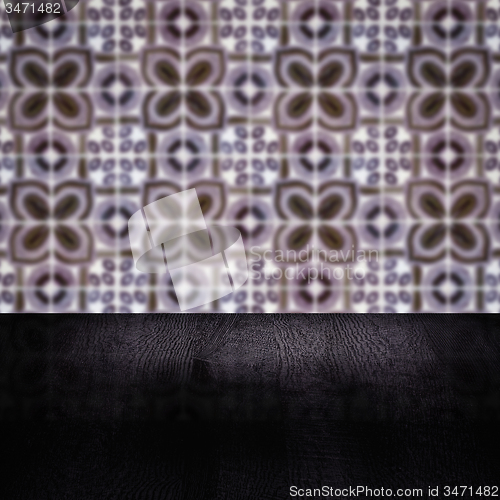 Image of Wood table top and blur vintage ceramic tile pattern wall