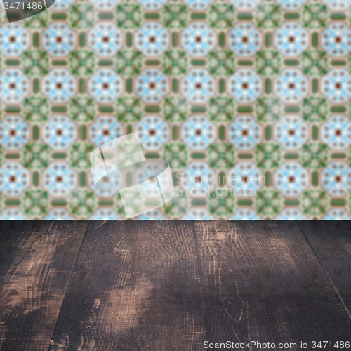 Image of Wood table top and blur vintage ceramic tile pattern wall