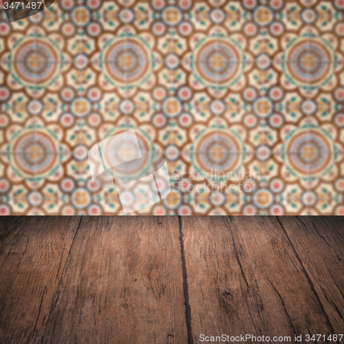 Image of Wood table top and blur vintage ceramic tile pattern wall