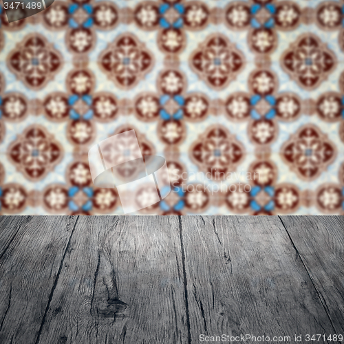Image of Wood table top and blur vintage ceramic tile pattern wall