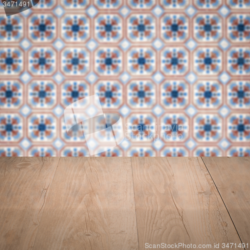 Image of Wood table top and blur vintage ceramic tile pattern wall