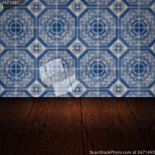 Image of Wood table top and blur vintage ceramic tile pattern wall