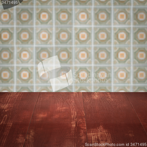 Image of Wood table top and blur vintage ceramic tile pattern wall