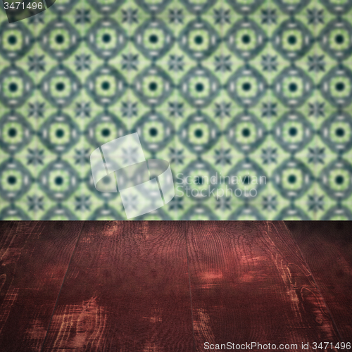 Image of Wood table top and blur vintage ceramic tile pattern wall