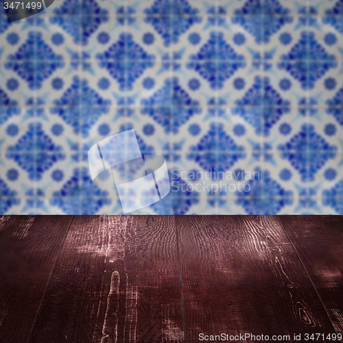 Image of Wood table top and blur vintage ceramic tile pattern wall