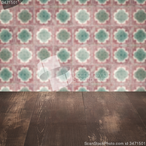 Image of Wood table top and blur vintage ceramic tile pattern wall