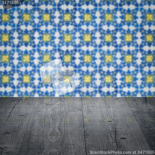 Image of Wood table top and blur vintage ceramic tile pattern wall