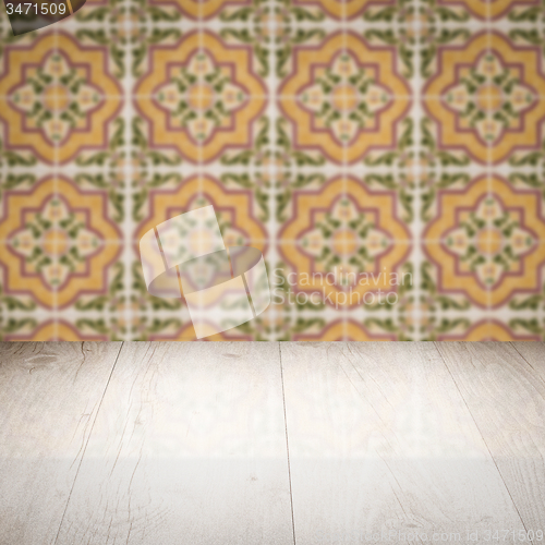 Image of Wood table top and blur vintage ceramic tile pattern wall