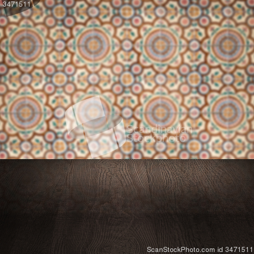 Image of Wood table top and blur vintage ceramic tile pattern wall
