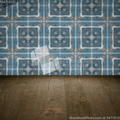 Image of Wood table top and blur vintage ceramic tile pattern wall