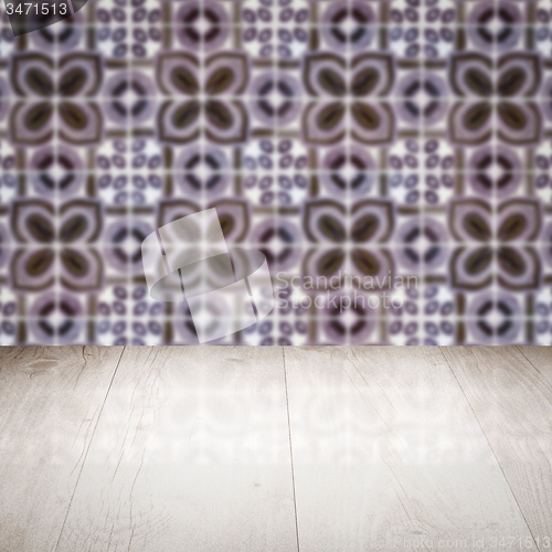 Image of Wood table top and blur vintage ceramic tile pattern wall