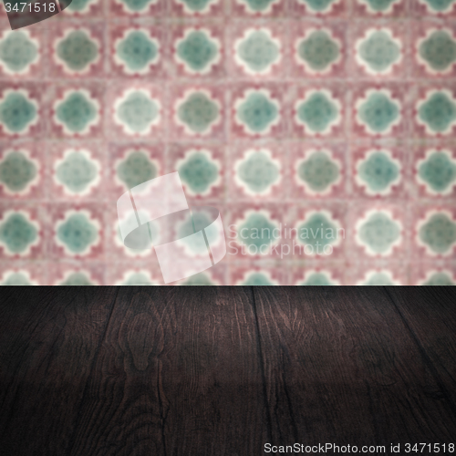 Image of Wood table top and blur vintage ceramic tile pattern wall