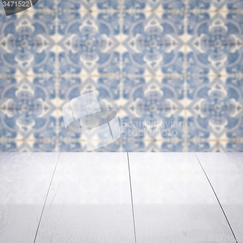 Image of Wood table top and blur vintage ceramic tile pattern wall